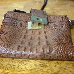 Brahmin crossbody with compartments inside for cards and other accessories.